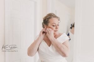 Bride putting on her earings in Boswells flat