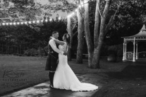 Bride and groom at night in Carlton Hotel gardens