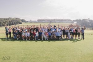 Group of golfers standing in front of Turnberry Hotel