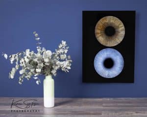 Iris Photography art work on wall. White vase on table 